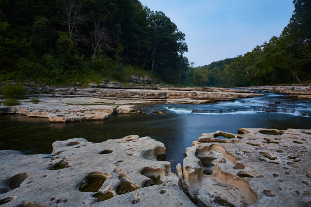istock River with giant flat rocks and small waterfalls with a green forest at Cataract Falls 1491318941