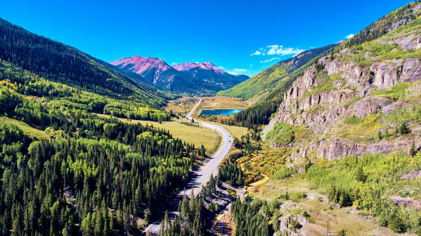 istock Road through the valley of mountains with lake 1491319033