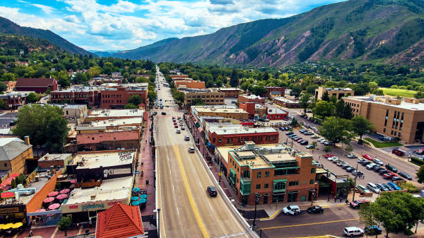 istock Road through town in valley with mountains 1491319043