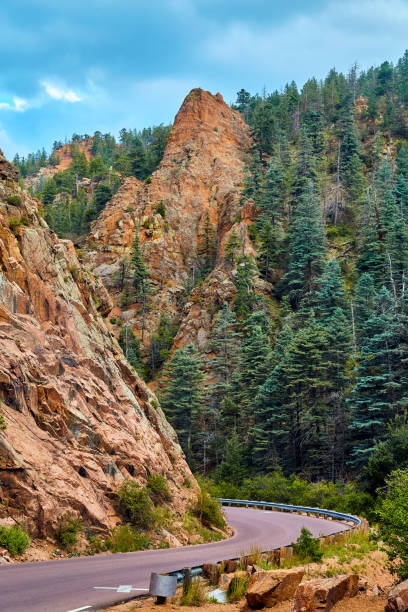 istock Road through valley with large rock mountain pillars and pine trees 1491319049