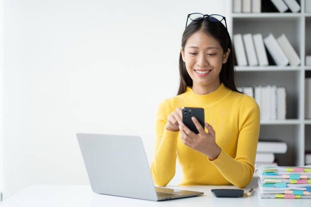 istock Beautiful businesswoman using smartphone while working at the office desk. 1491319223