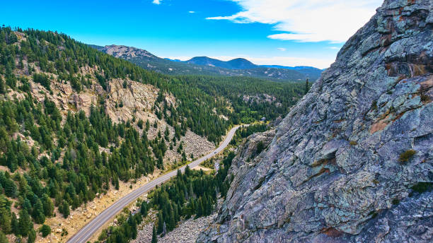 istock Stone peak mountains next to highway in a valley of pine trees 1491321240