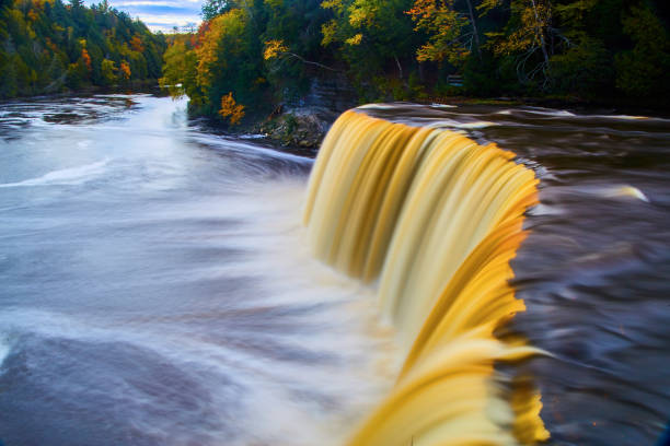 istock Tahquamenon Falls with golden brown waterfall and swirling river during fall 1491322179