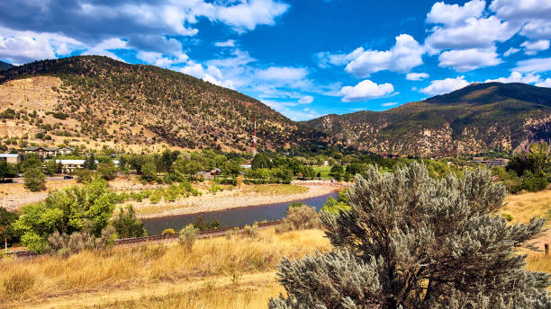 istock Train tracks and river in desert mountains 1491322688