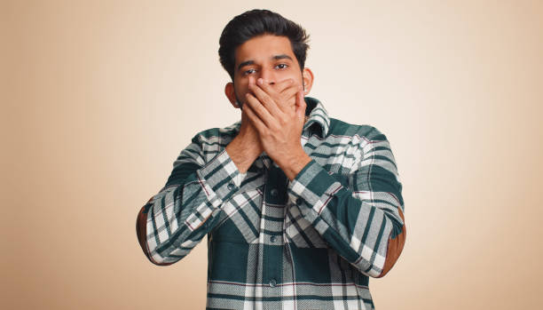 istock Frightened indian man closing mouth with hands refusing to tell terrible secret, unbelievable truth 1491322961