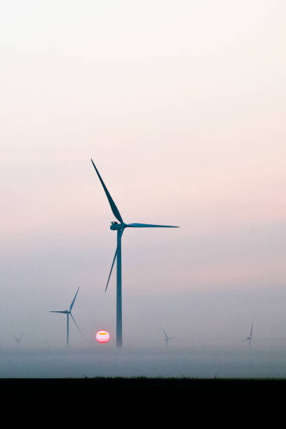 istock Two windmills silhouetted against the morning sun 1491323138