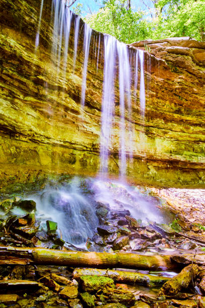 istock View of waterfall dripping off of cliffs onto rocks 1491324255