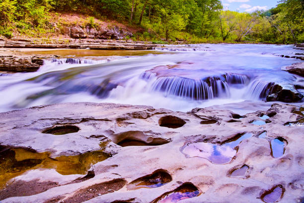 istock Waterfall with rocky surface filled with holes 1491324693