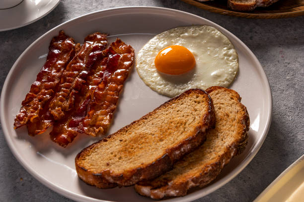 istock Breakfast with fried Bacon and Eggs, toast, and Coffee 1491325744
