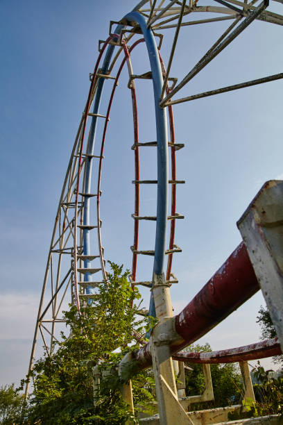 istock Worm's eye view of abandoned roller coaster in a broken down theme park 1491325933