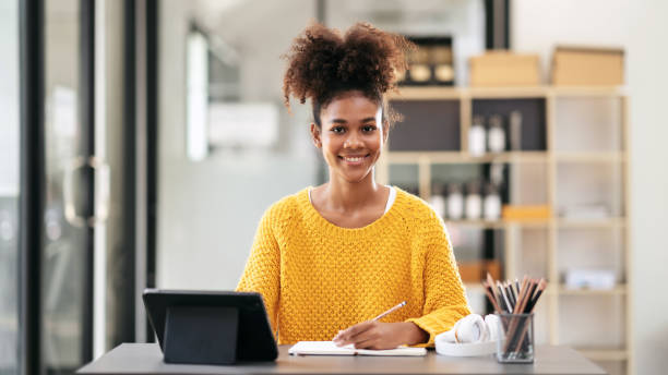 istock African american student woman in sweater watching e-learning to 1491326144