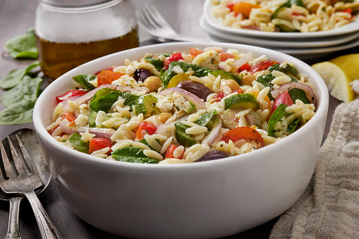 Mediterranean Orzo Salad with Baby Spinach, Feta, Cherry Tomatoes, Cucumber, Olives, Red Onion, Red Peppers and Chick Peas
