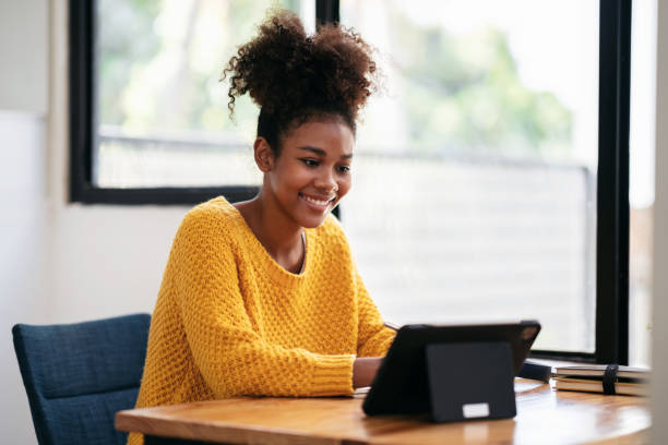 istock African american student woman in sweater using digital tablet t 1491329155
