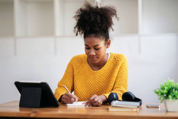 istock African american student woman in sweater watching e-learning to 1491329166