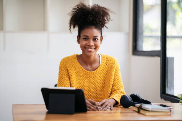 istock African american student woman in sweater using digital tablet t 1491329171