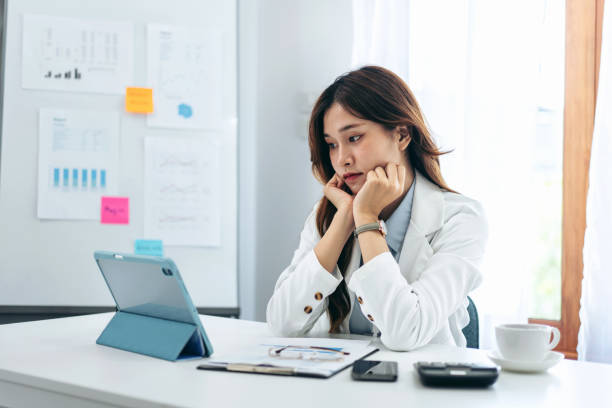 istock Businesswoman in suit is reading business data for thinking and 1491329224