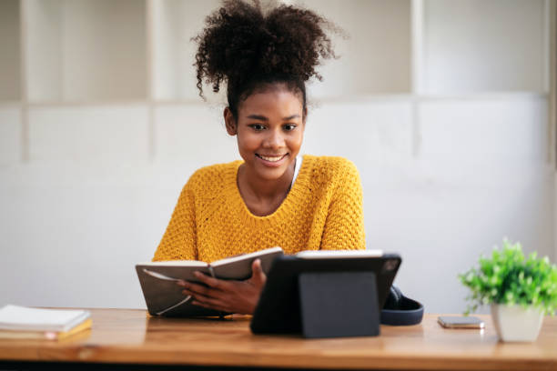 istock African american student woman in sweater watching e-learning to 1491330746