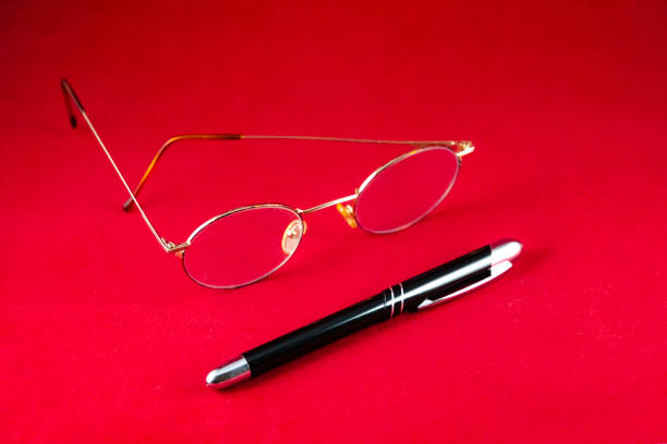 Equipment of a journalist writer: glasses and a stylish pen stock photo