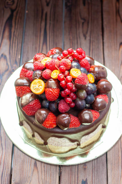 istock Rich chocolate cookie cake decorated with sauce and fresh berries, strawberry, cherry and blueberry 1491332476