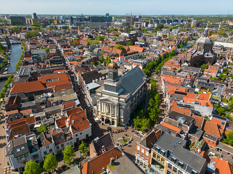 This aerial drone photo shows the Hartebrugkerk in Leiden at the shopping street named Haarlemmerstraat. Leiden is a beautiful old city in Zuid-holland, the Netherlands.