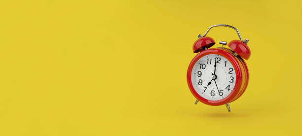istock Red alarm clock hangs in the air on yellow background 1491334832