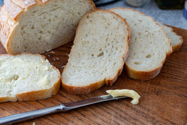 istock Sliced bread on a wooden chopping board, battered sandwich, morning domestic breakfast routine. 1491335563