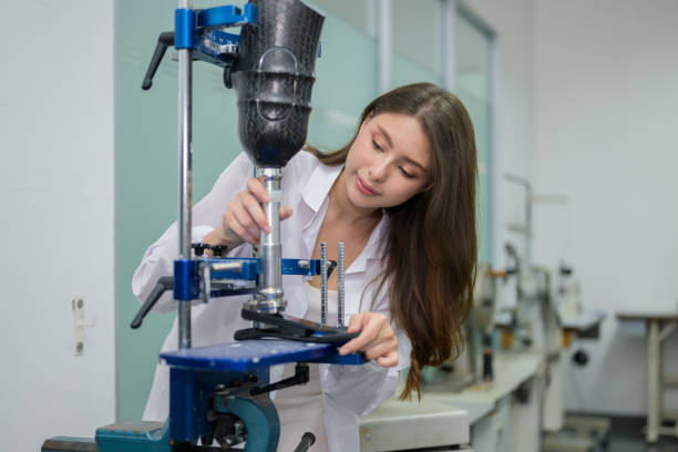 istock Female technician assembling and fixing parts of modern prosthetic leg 1491335616