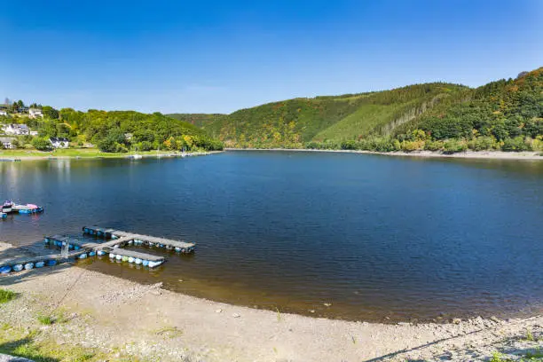 Pebble beach at the village of Rurberg at Lake Rur in the Eifel, Germany.