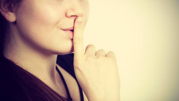 istock Woman showing silence gesture with finger 1491338498