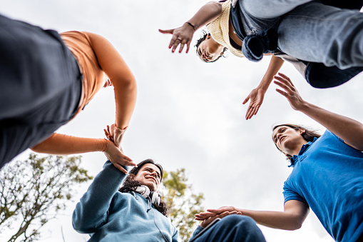 Low angle view of student friends a having fun outdoors