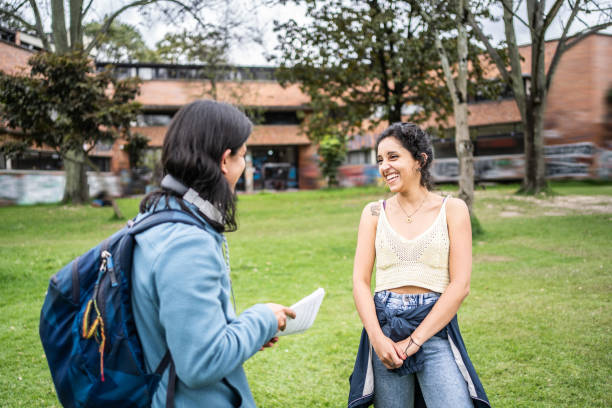 istock Young woman talking with her friend on the university campus 1491341284