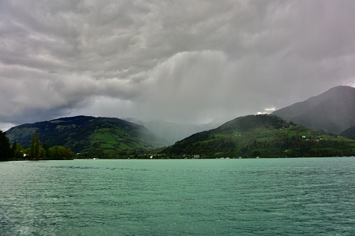 Dramatic sky over a mountain lake. The sky before a thunderstorm over the lake and mountains. The sky before a thunderstorm over the Austrian Alps. Lake Zell before a thunderstorm.