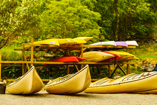 Kayaks on water shore. Rental centre. Travel, holidays and active lifestyle.