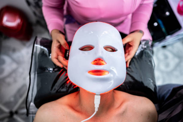 istock Dermatologist/aesthetician putting a photon mask on a patient at clinic 1491342850