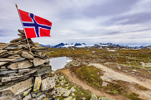 Norwegian flag on a cruising ferry boat in the fjords of Norway. Lysefjorden.