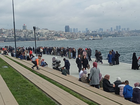 Istanbul, Türkiye – April 21, 2023: The people who came to visit the amphibious assault ship TCG Anadolu (L-400) anchored in Sarayburnu Port formed long queues.