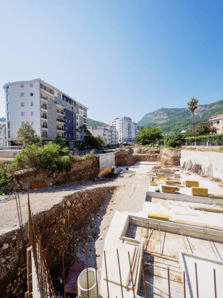 istock Excavator works at a construction site next to the frames for pouring the foundation 1491347985