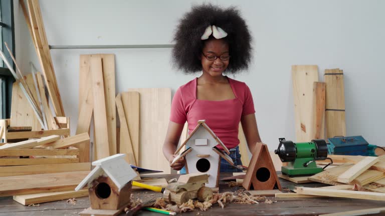 A little inventor working as a woodworker to craft nest woodworking at a workshop