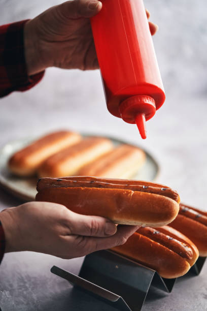 istock Preparing Hot Dog with Mustard and Ketchup 1491348959