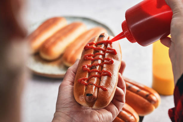 istock Preparing Hot Dog with Mustard and Ketchup 1491348960