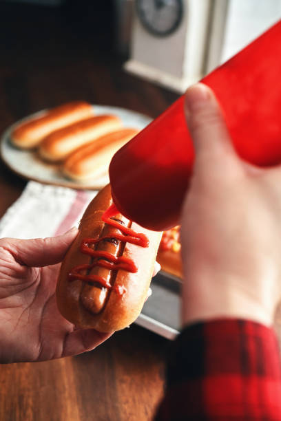 istock Preparing Hot Dog with Mustard and Ketchup 1491348976