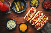 Variation of Hot Dogs with Roasted Onions, Pickle Relish, Mustard, Ketchup and Various Toppings