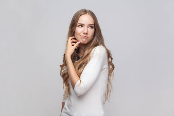 woman thinking, looking away, having puzzled confused facial expression, pondering, - pensive question mark teenager adversity imagens e fotografias de stock