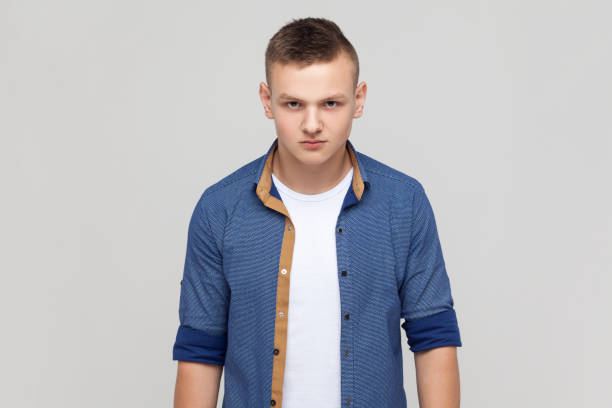 istock Enraged teenager boy standing looking at camera, expressing wild anger and hate, feeling crazy. 1491351860