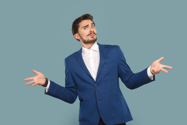 istock Confused puzzled man standing with spread hands, asking what with uncertain angry expression. 1491352494