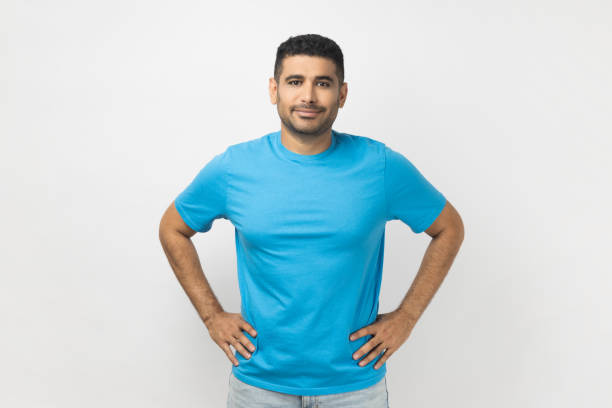 istock Happy delighted man standing looking at camera, expressing positive emotions, keeps hands on hips. 1491352541