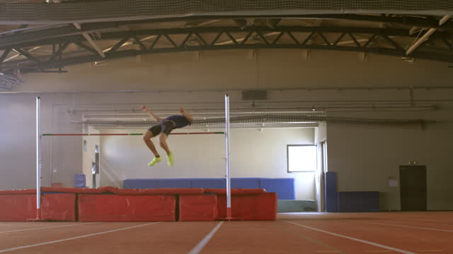 DS Male high jumper jumping over the bar in practice