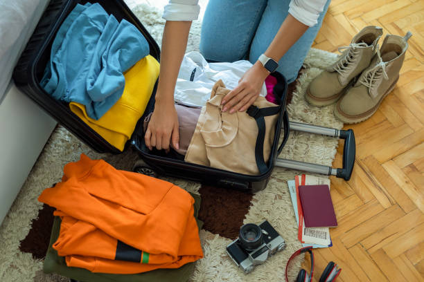 istock Woman preparing suitcase for holidays 1491355785