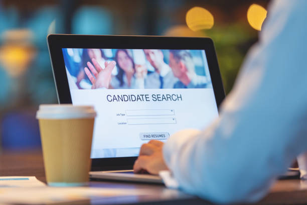Businessman looking at recruitment website on a laptop computer. Businessman looking at recruitment website on a laptop computer. Candidate search page with job type, resume and location buttons good cv stock pictures, royalty-free photos & images