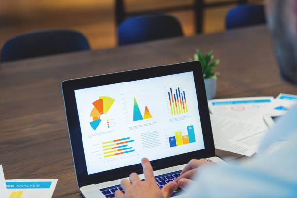 istock Close up of businessman using a laptop with graphs and charts on a laptop computer. 1491361302